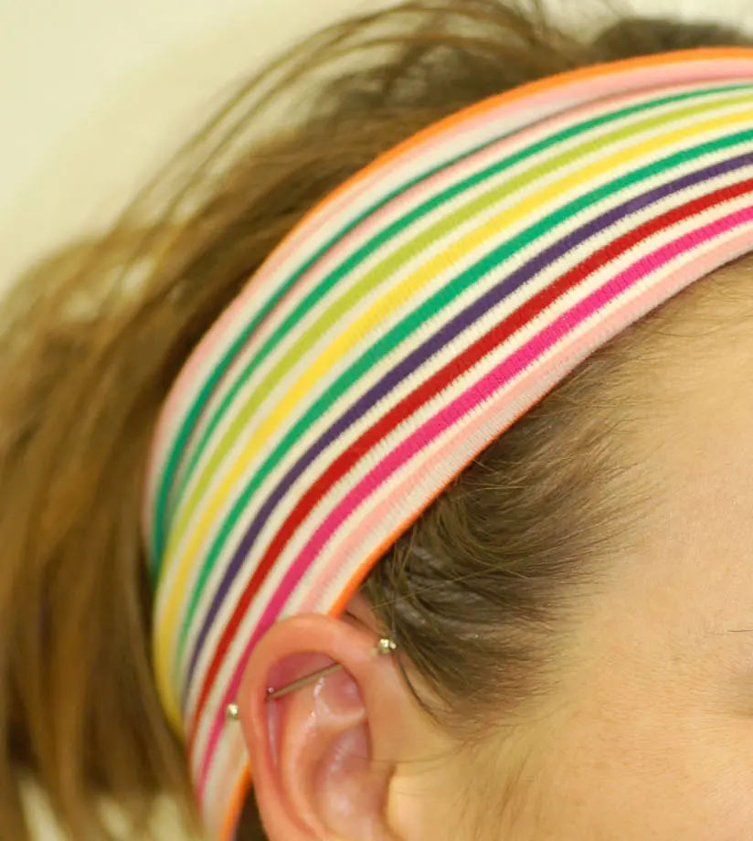 A straight barbell spanning two holes in the upper ear rim, with a ball at each end