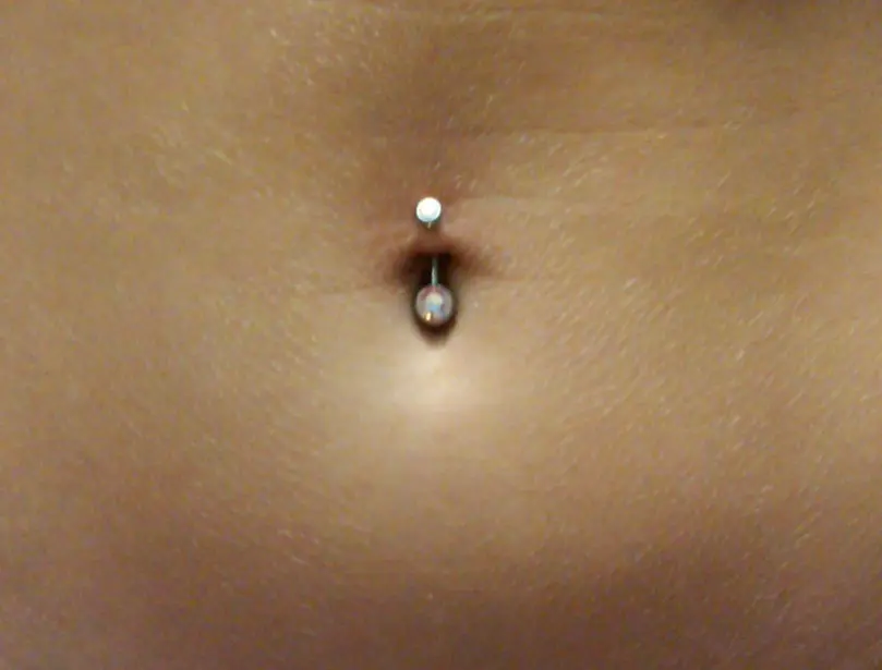 A curved barbell in a healed navel piercing