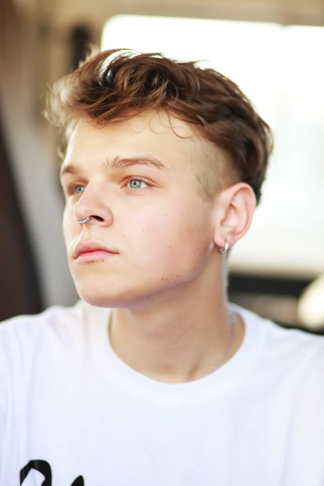 A septum ring sitting below the nose, through the soft tissue in front of the cartilage