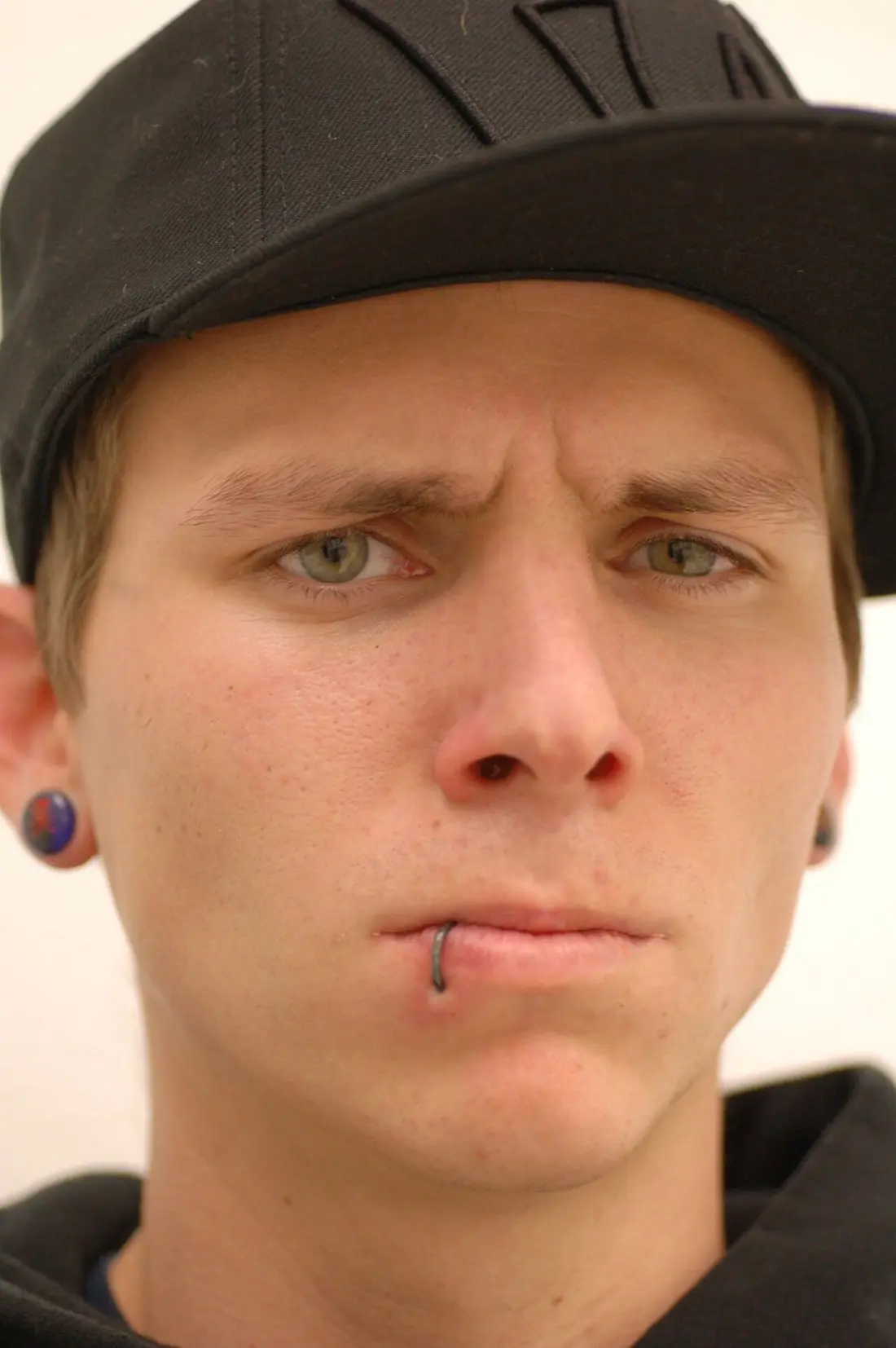 A thin dark ring through the lower lip, off to one side of centre