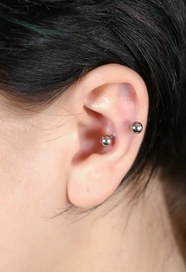 A curved barbell through the inner ridge of the antihelix, the fold of cartilage just inside the outer rim of the ear